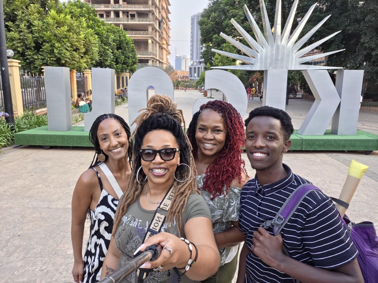 Visitors at the KIGALI sign in the Car Free Zone, a stop on our Kigali city tours