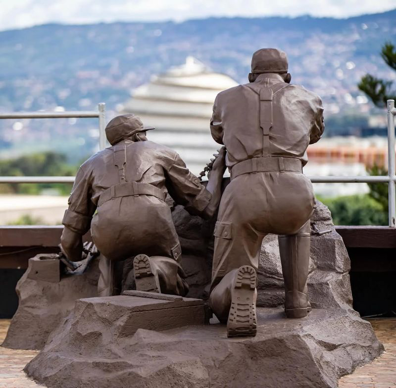 Statues at the Campaign Against Genocide Museum with the Kigali Convention Centre dome behind, Kigali Past & Present group tour