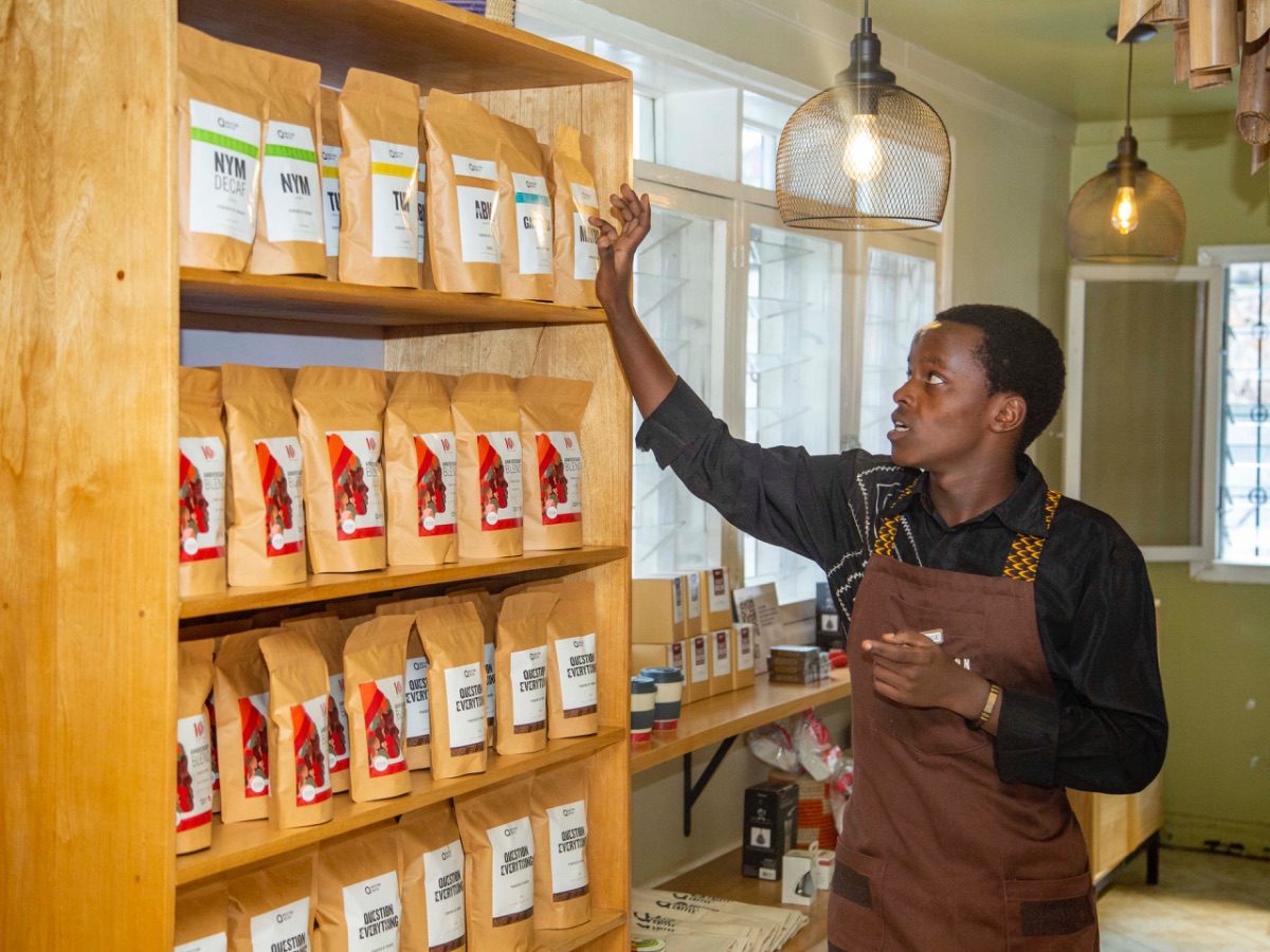 A Question Coffee barista in Kigali explains the single-origin Rwandan coffees on the shelf